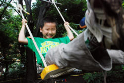 写真:ブランコで遊ぶ男の子