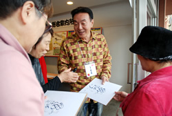 写真:サインに応じる三笑亭夢之助さん