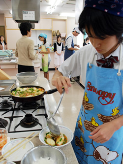 写真:真剣な表情で盛り付けをする中学生