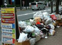 写真:大型看板とゴミの不法投棄の山