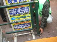 写真:ガードパイプにロックされた看板