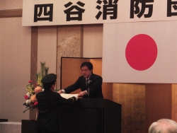 写真:四谷消防団始式で表彰する吉住区長