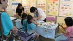 写真:折り紙で遊ぶ子供たち